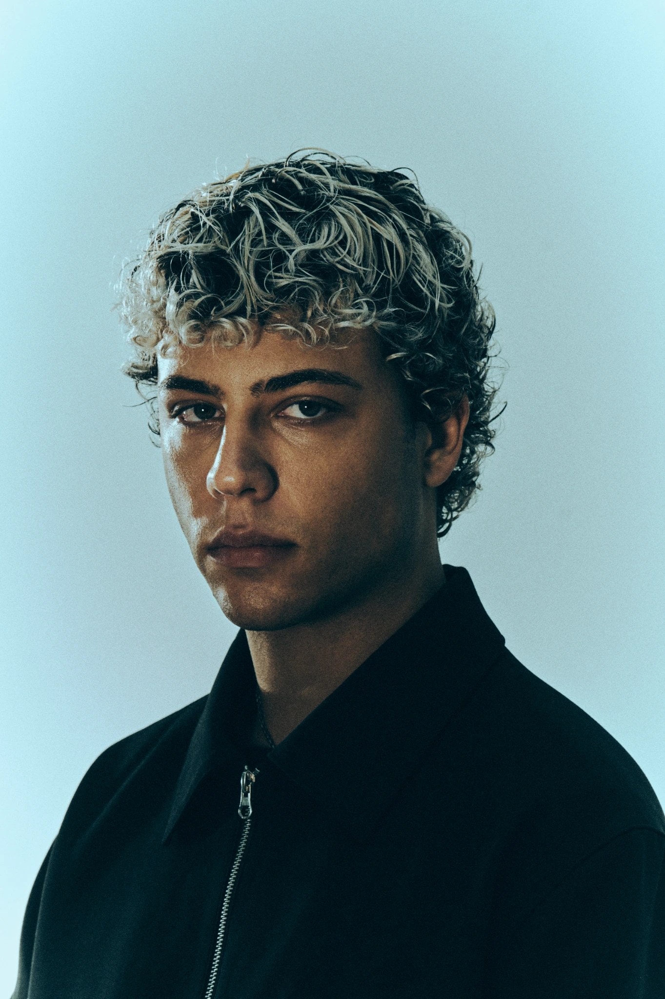 Bleached curly crop, three-quarter portrait