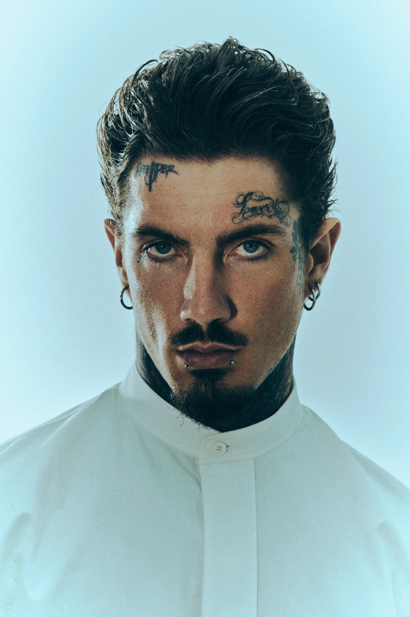 Slicked-back undercut with volume on top, front-facing portrait